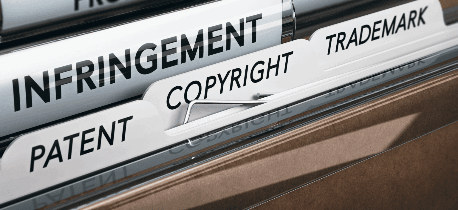 Close up of files in a filing cabinet with the words 'Infringement,' 'patent,' 'copyright,' and 'trademark' on them | Daniel Stark Law